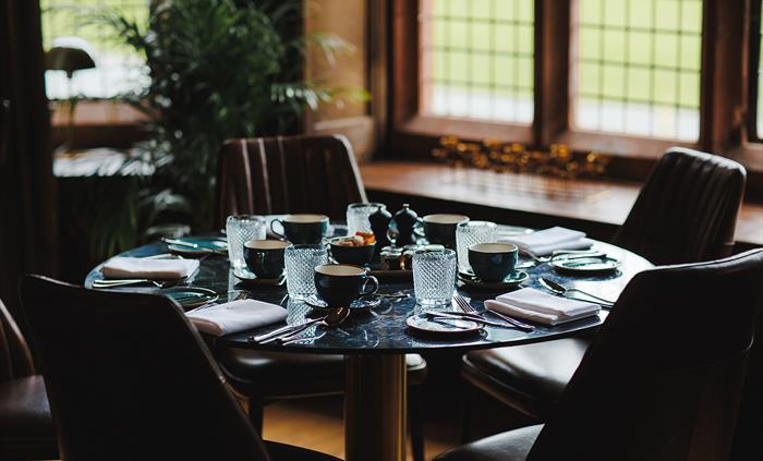 A dining table set up in a hotel restaurant.